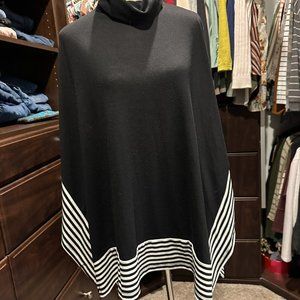 Black poncho sweater with white stripes